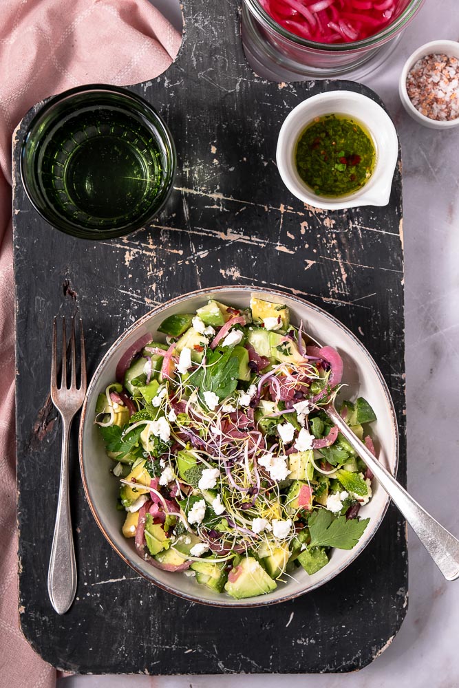 Makkeiljk recept voor gezonde avocado salade met komkommer, feta, verse munt en zoetzure rode ui, geserveerd met een frisse citroendressing, perfect als bijgerecht of lichte lunch.